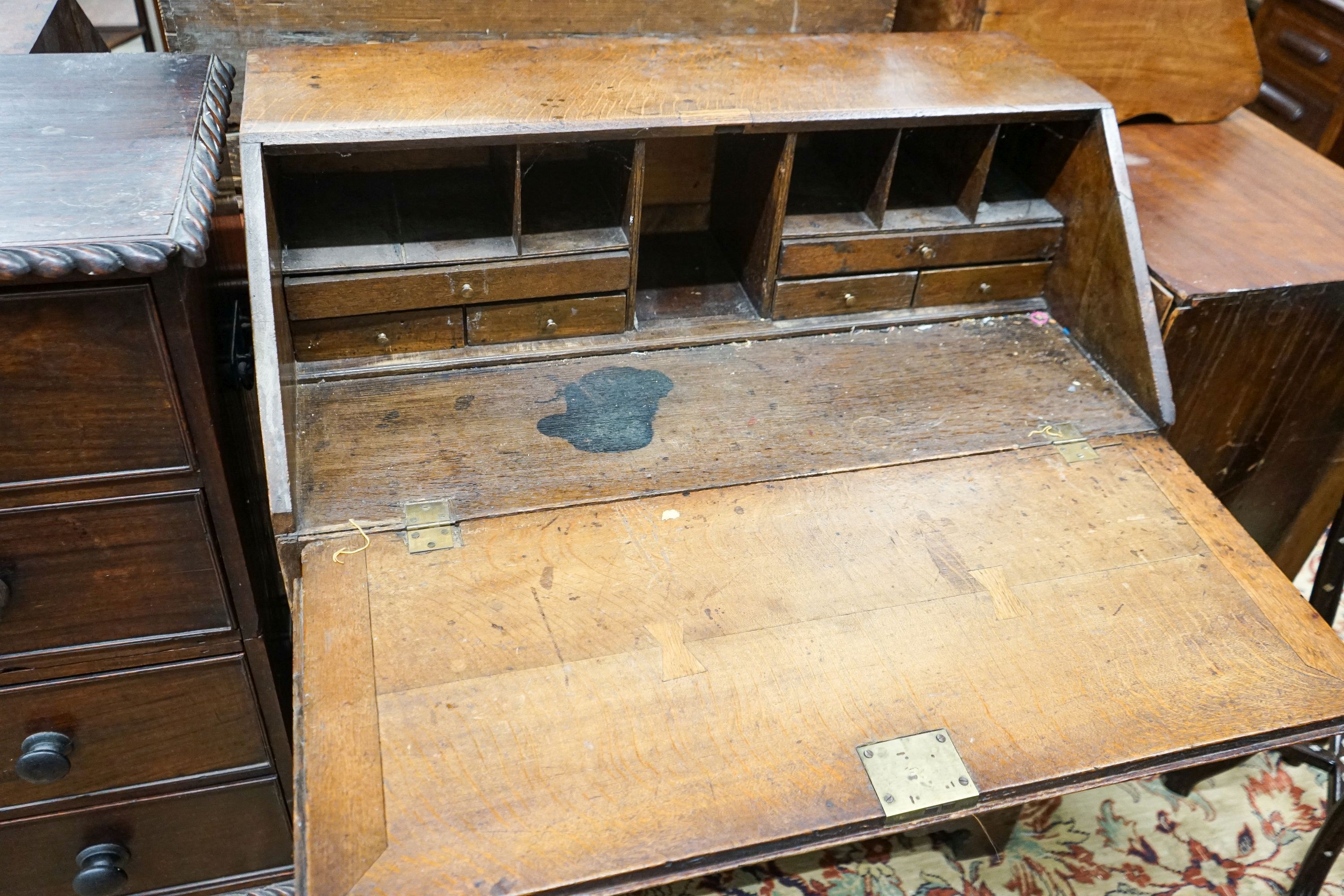 A George III later carved oak bureau, width 91cm, depth 50cm, height 106cm